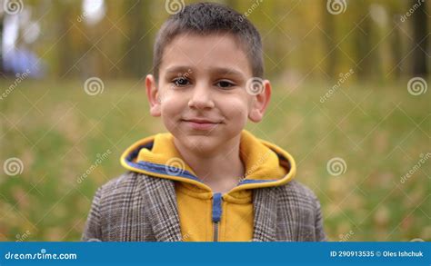Front View Portrait Of Cute Boy Smiling Looking At Camera Standing