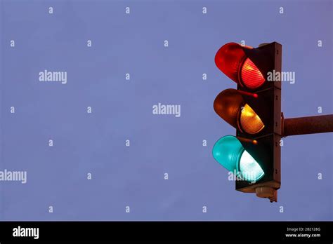 Traffic Lights Switched To Red Yellow Green At Dusk Hi Res Stock