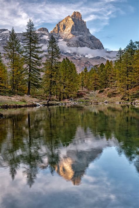 The Matterhorn Cervinia At Sunset Reflected In Lake Blue Just By