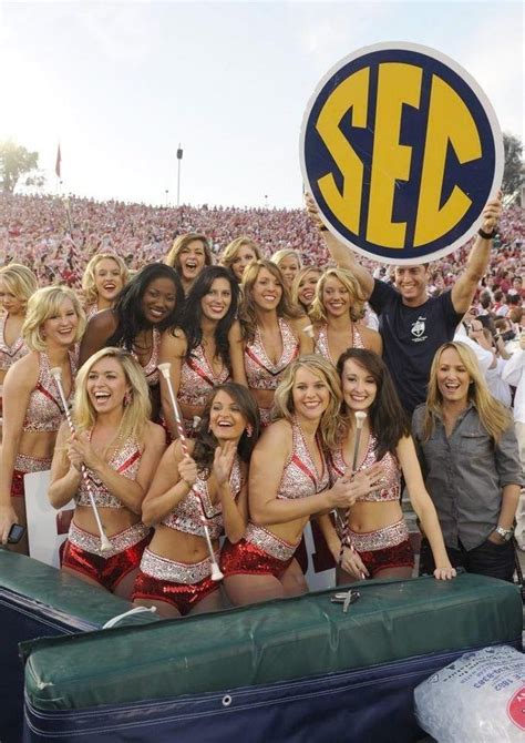 A Group Of Cheerleaders Pose For A Photo At A Football Game