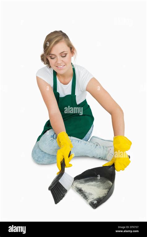 Smiling Young Maid Using Brush And Dust Pan Stock Photo Alamy