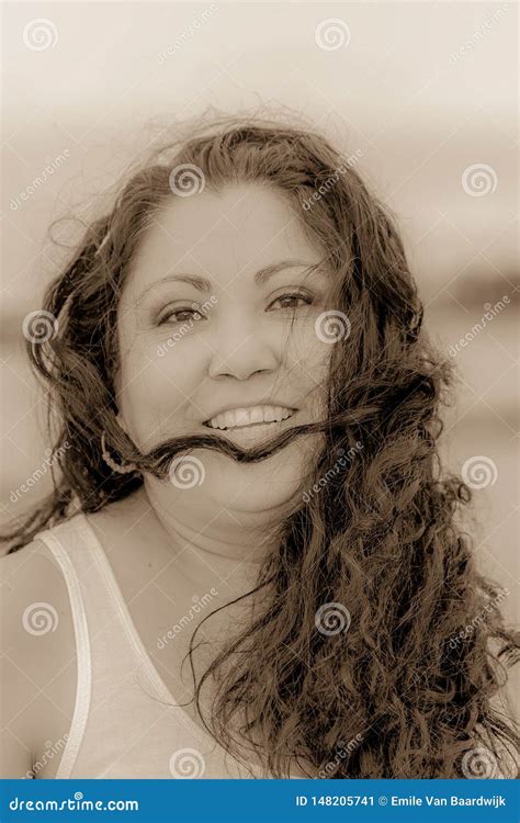 Beautiful Black And White Image Of A Happy Smiling Mexican Woman With Long Hair Tousled By The