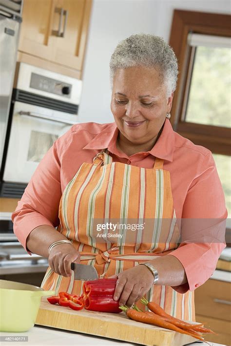 Black Woman Cooking In Kitchen High Res Stock Photo Getty Images