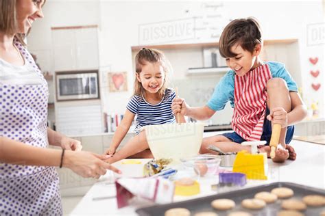Mother And Children Baking Cookies In Kitchen Stock Photo Dissolve