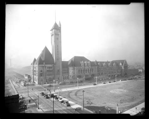 An Old Black And White Photo Of A Large Building With A Clock Tower In