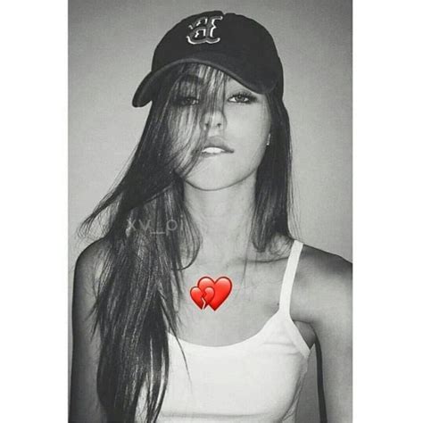 Black And White Photograph Of A Woman Wearing A Baseball Cap With Two Hearts On It