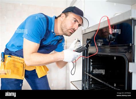 One Expert Repairman Fixing A Broken Kitchen Oven Stock Photo Alamy