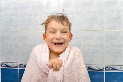 A Boy In The Shower Wrapped In A Towel A Joyful Child After Bathing