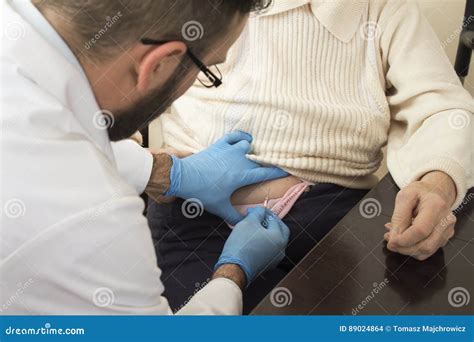 Doctor Gives A Shot In The Belly Of An Old Woman Stock Photo Image