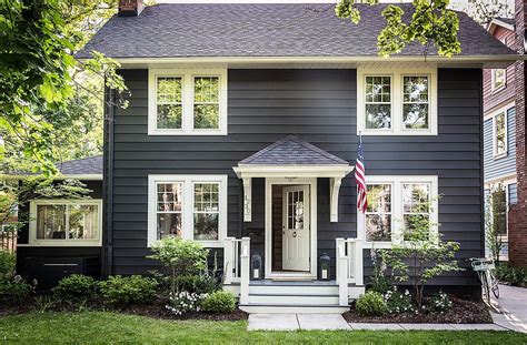 Worker painting wood with paint brush. 7 Designer Ideas for Exterior Paint Colors | Colonial ...