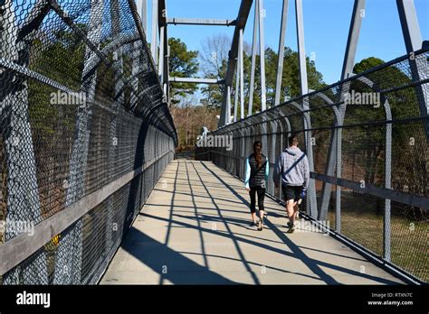 A Couple Crosses The Reedy Creek Trail Pedestrian Bridge Over The 440