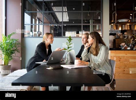 Female Coworkers Talking In Cafe Stock Photo Alamy