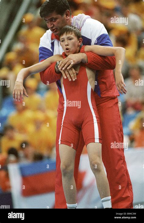 A Coach Instructs Young Wrestler Imil Sharafetdinov Foreground During