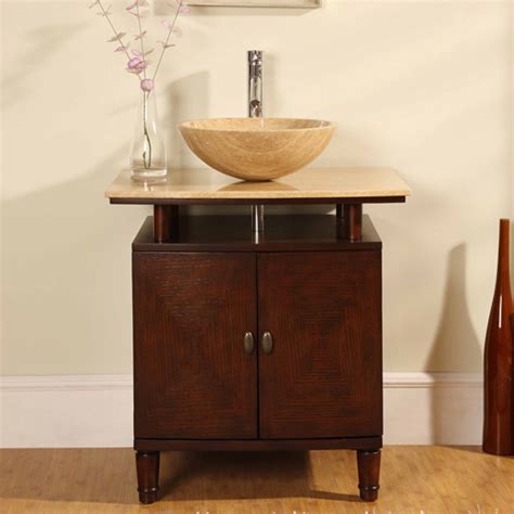 A vessel sink sits on top of the countertop. 29 Inch Modern Vessel Sink Bathroom Vanity with Travertine