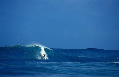 a surfer dropping into a big tube at backdoor pipeline north shore oahu secret love north