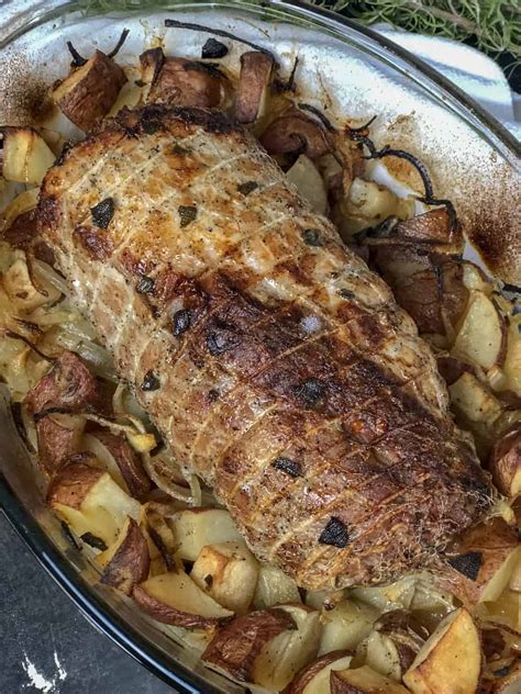 Put the pork in a lightly oiled roasting pan and scatter the potatoes around it. Roast Pork Loin with Apples, Potatoes and Onions - Whatcha ...