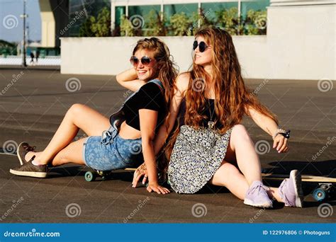 Young Beautiful Redhead Girls With Longboard And Skateboard Posing