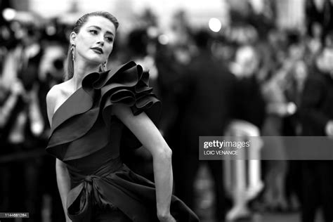 Us Actress Amber Heard Poses As She Arrives For The Screening Of The