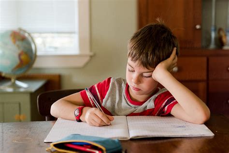 Little Boy Doing His Homework By Stocksy Contributor Léa Jones