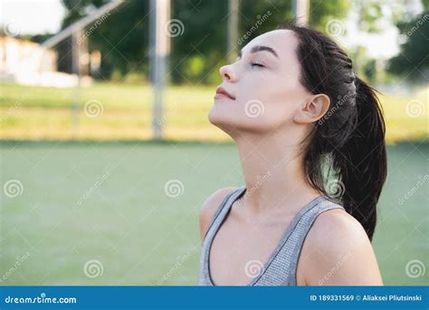 Side View Of Young Beautiful Female With Closed Eyes Breathing Deeply While Doing Respiration