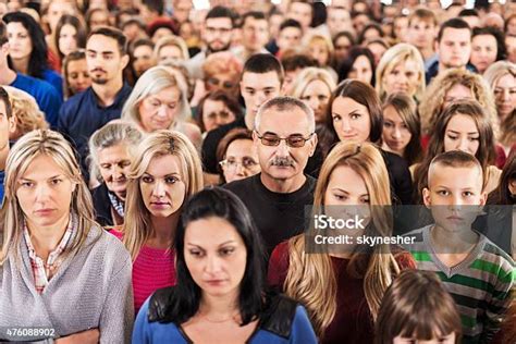 Large Group Of Serious People Standing Together Stock Photo Download