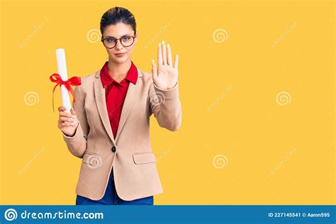 Young Beautiful Woman Wearing Glasses Holding Graduate Degree Diploma With Open Hand Doing Stop