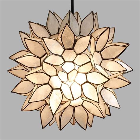 The strands of translucent natural capiz shells featured on the transitional lighting collection lend an organic feel to this elegant collection and diffuse the light with a fantastic effect. Cost Plus World Market Small Capiz Lotus Pendant Lamp ...