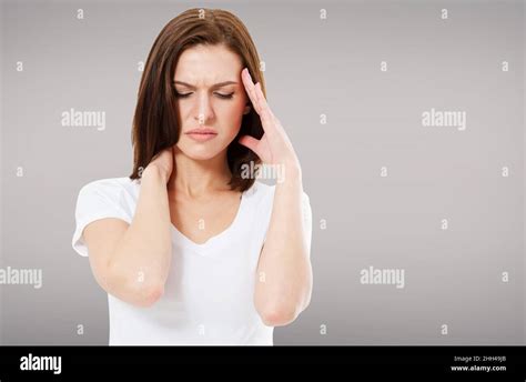Suffering Brunette Woman On Grey Background Headaches Stock Photo Alamy