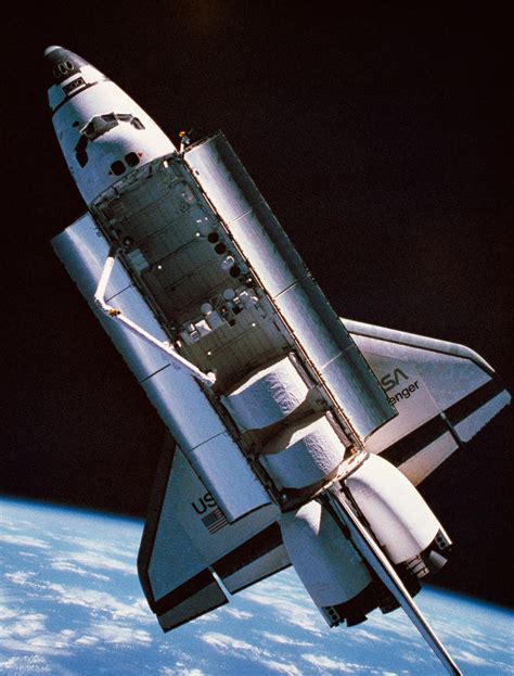 The Space Shuttle With Cargo Bay Open Orbiting Above Earth By Stockbyte