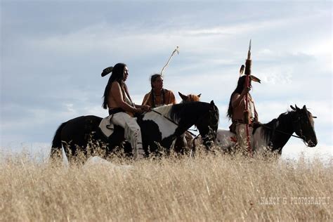 Two Native American Men On Horseback With Their Horses In Tall Grass