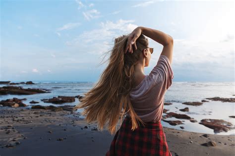 Backside View Of Romantic Beautiful Fit Hipster Girl Traveller Long Hair Enjoying Blue Ocean