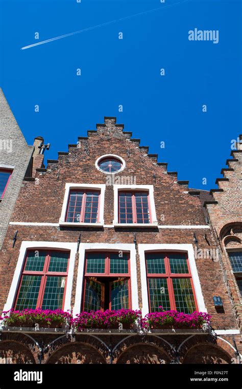 Medieval House With Flowers And Blue Sky Bruges Brugge Stock Photo