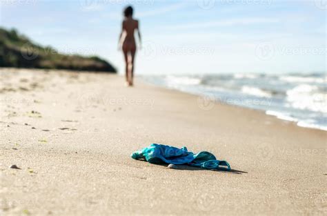 Swimsuit In The Sand On The Beach And Naked Female Figure 17521809