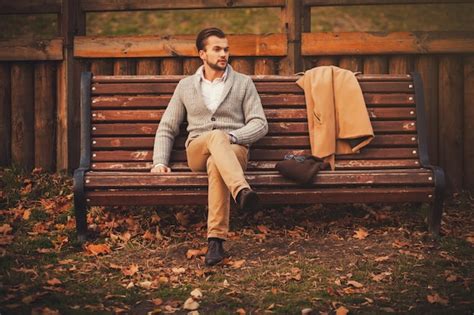 Premium Photo Handsome Young Man Sitting On The Bench