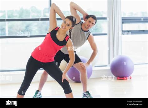 Two people doing power fitness exercise at yoga class Stock Photo - Alamy
