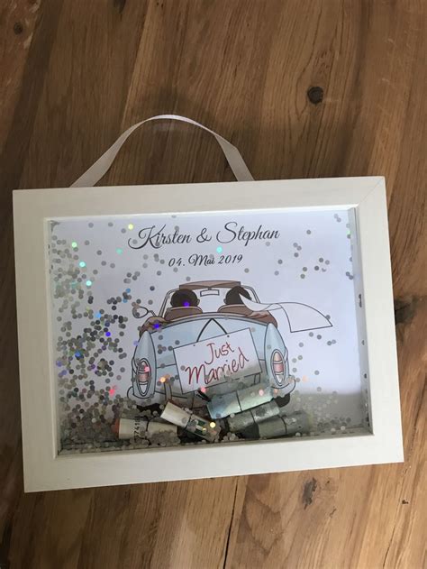 A Wedding Car With The Bride And Groom On Top Is Framed In White Paper