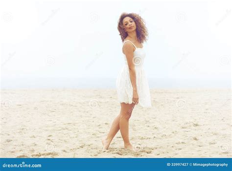 Beautiful Woman In White Dress Walking On Sand At The Beach Stock Image