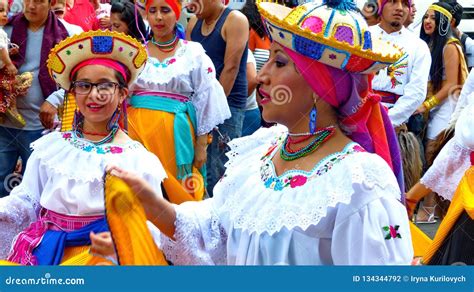 Dancers In Ecuadorian Traditional Colorful Dresses During Paseo Del