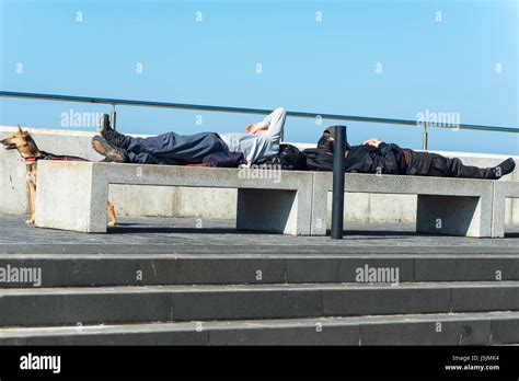 Two Men Resting On Concrete Seats Along The Seafront In Margate Kent
