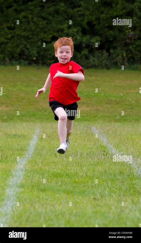 A Boy Running A Race On School Sports Day In An English School Stock
