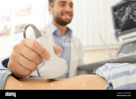 Doctor Conducting Ultrasound Examination Of Woman In Clinic Stock Photo