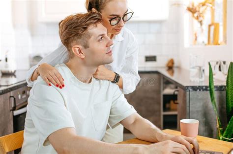 Caring Wife Supporting Husband He Works On Freelance Stock Photo