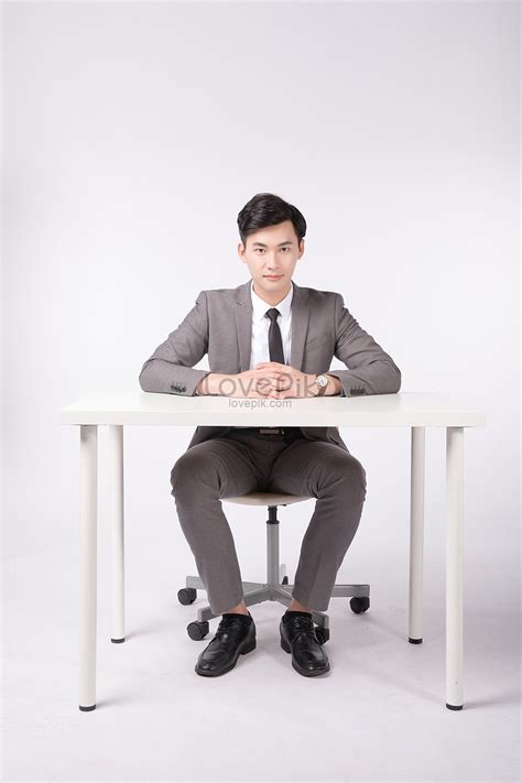 A Business Man Sitting At The Table Picture And Hd Photos Free