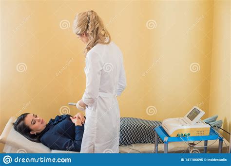 Beautiful Gynecologist Does Cardiotocography Of The Fetus A Young
