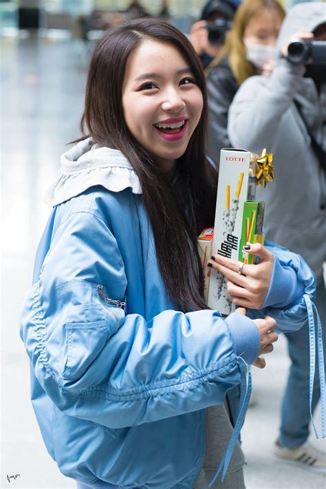 A Woman Is Smiling And Holding A Package