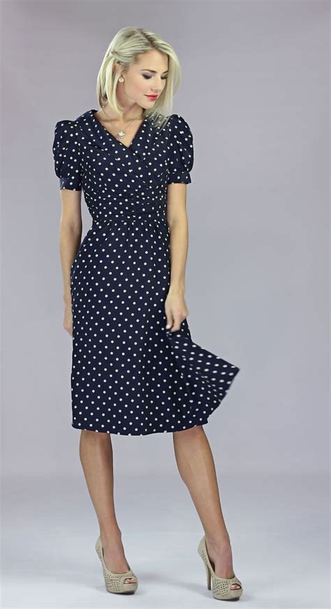 a dress with a vintage air about it the ariana dress in navy polka dot is sure to give you that