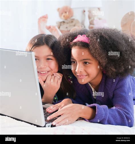 Girls Using Laptop Together Stock Photo Alamy