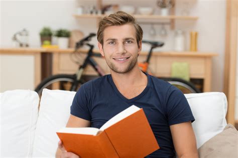 Man Sitting On Sofa Reading A Book Stock Photo Free Download