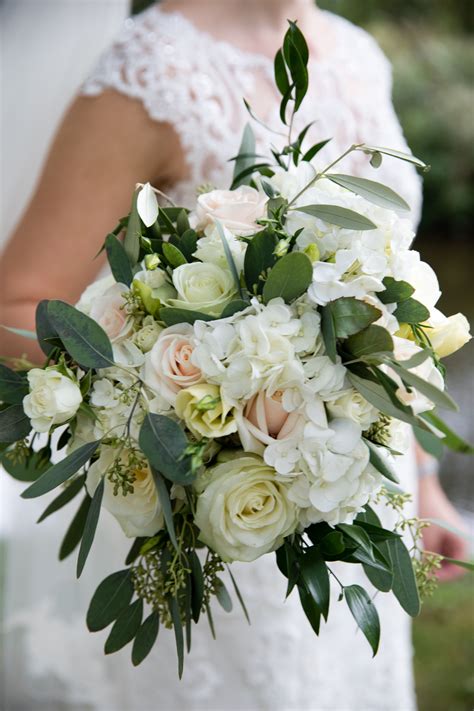 this elegant bridal bouquet was created using white and blush roses timeless and classic in it