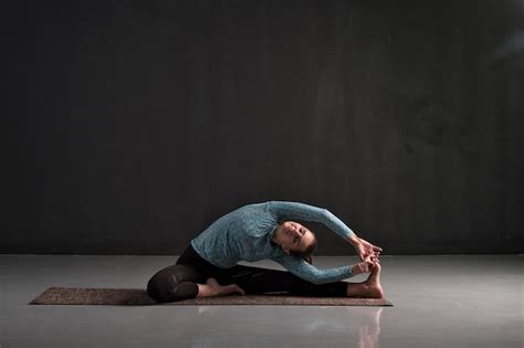 Premium Photo Woman Sitting In Yoga Pose Parivrtta Janu Sirsasana